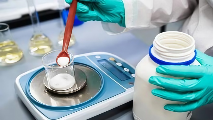 Laboratory technician testing powder sample after sieve analysis